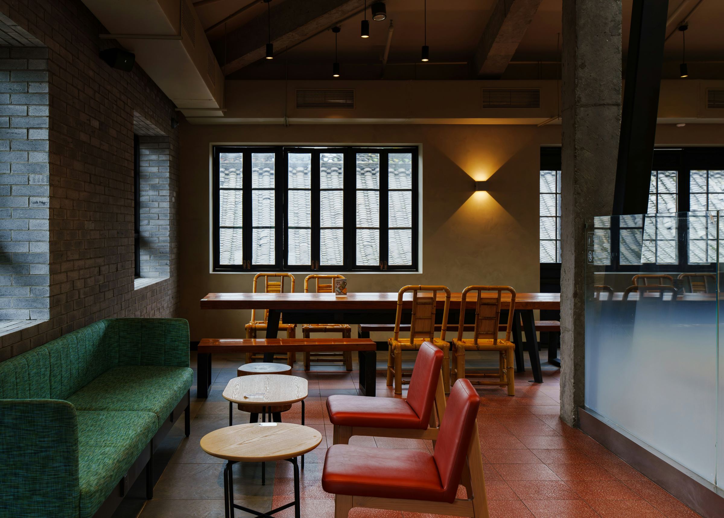 Loft-style restaurant with green sofa and mixed seating